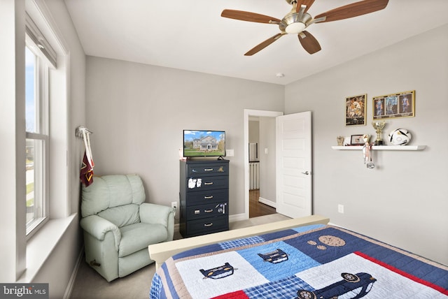 carpeted bedroom with baseboards and ceiling fan