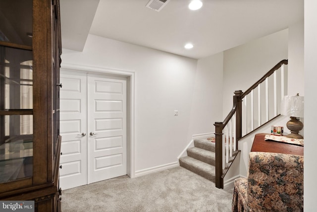 carpeted foyer with visible vents, baseboards, recessed lighting, and stairs