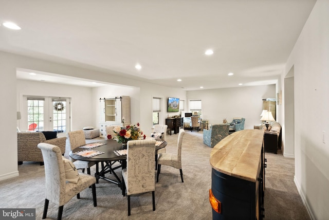 dining room featuring recessed lighting, light colored carpet, and baseboards