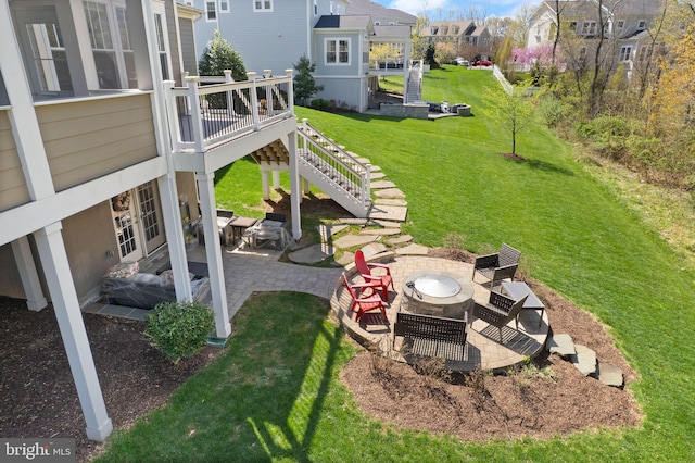 view of yard with a fire pit, a patio area, stairs, a wooden deck, and a residential view