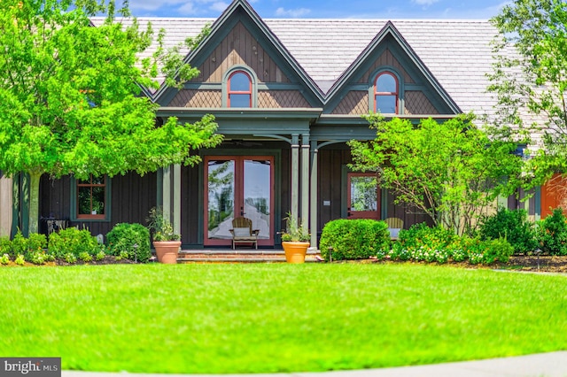 back of property featuring a porch and a lawn