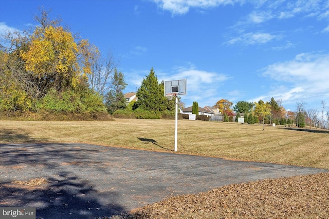 view of sport court featuring community basketball court and a yard