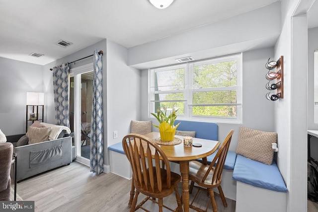 dining area featuring wood finished floors and visible vents