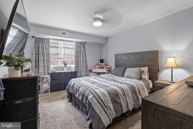 bedroom with carpet floors, a ceiling fan, and visible vents