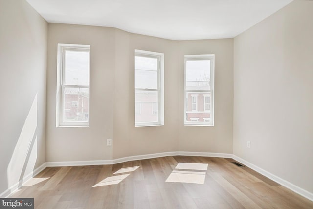 1820 Aiken St, Baltimore, MD 21213 - empty room with light wood-style floors, baseboards, and visible vents