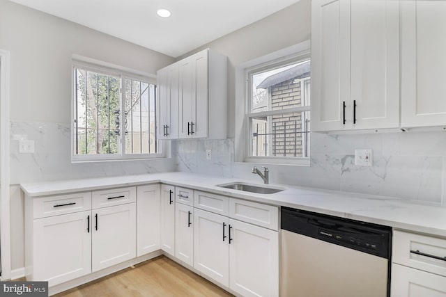 1820 Aiken St, Baltimore, MD 21213 - kitchen featuring light stone countertops, dishwasher, a sink, and white cabinets