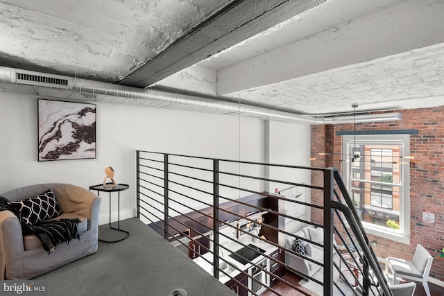1401 R St NW Unit 304, Washington, DC 20009 - interior space featuring visible vents, brick wall, and an upstairs landing