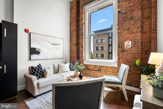 1401 R St NW Unit 304, Washington, DC 20009 - living room with baseboards, brick wall, and hardwood / wood-style floors