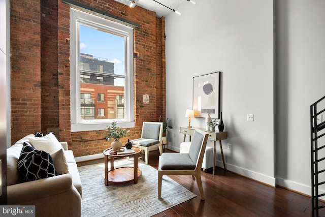 1401 R St NW Unit 304, Washington, DC 20009 - living area featuring baseboards, plenty of natural light, wood-type flooring, and brick wall