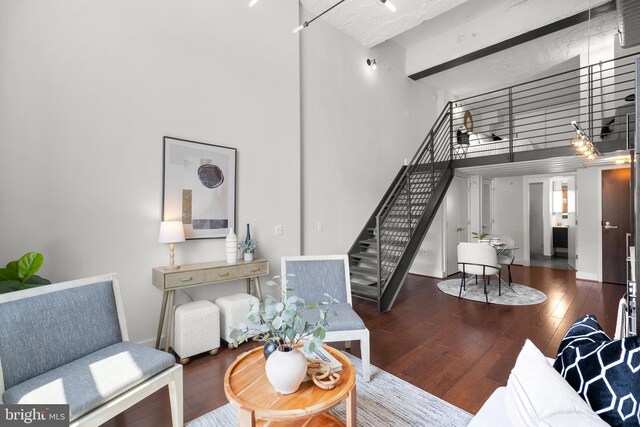 1401 R St NW Unit 304, Washington, DC 20009 - living area with stairs, baseboards, hardwood / wood-style flooring, and a towering ceiling