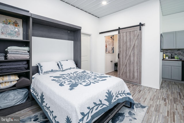 129 Prince Georges Dr, Dagsboro, DE 19939 - bedroom with a barn door, recessed lighting, baseboards, and light wood-type flooring