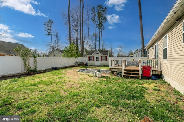 129 Prince Georges Dr, Dagsboro, DE 19939 - view of yard with a fenced backyard, a wooden deck, and an outbuilding