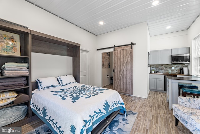 129 Prince Georges Dr, Dagsboro, DE 19939 - bedroom featuring recessed lighting, light wood-style floors, and a barn door