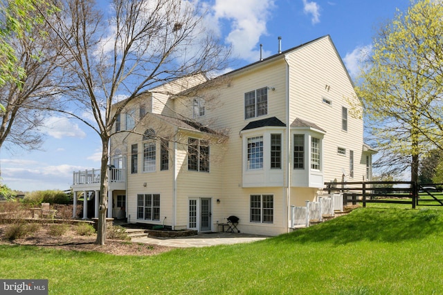 back of house with a yard, a patio, and fence