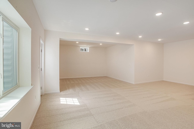 spare room with light colored carpet, baseboards, visible vents, and recessed lighting