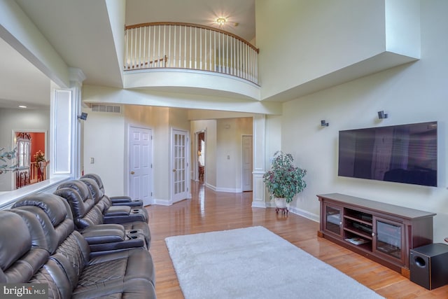 113 Anna Ct, Middletown, DE 19709 - living room featuring a towering ceiling, baseboards, wood finished floors, and visible vents