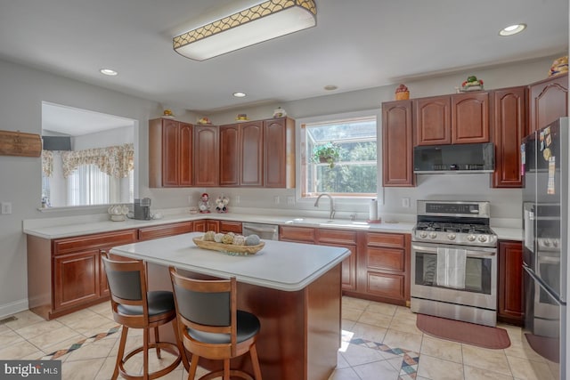 113 Anna Ct, Middletown, DE 19709 - kitchen with a kitchen island, a sink, light countertops, light tile patterned floors, and stainless steel appliances