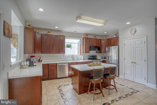 113 Anna Ct, Middletown, DE 19709 - kitchen featuring light countertops, light tile patterned flooring, appliances with stainless steel finishes, and a kitchen breakfast bar
