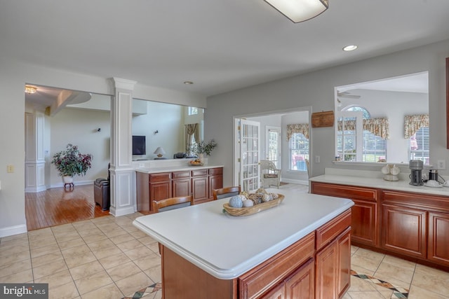 113 Anna Ct, Middletown, DE 19709 - kitchen featuring light countertops, light tile patterned floors, a center island, and ornate columns