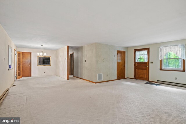 unfurnished living room with a notable chandelier, visible vents, light carpet, and a baseboard radiator