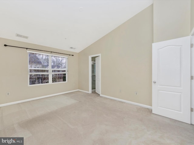 unfurnished room featuring light carpet, high vaulted ceiling, visible vents, and baseboards