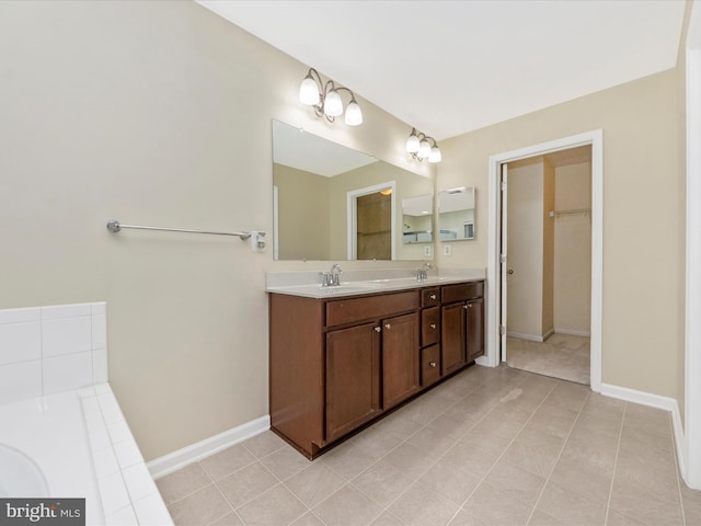 bathroom with double vanity, baseboards, and a sink