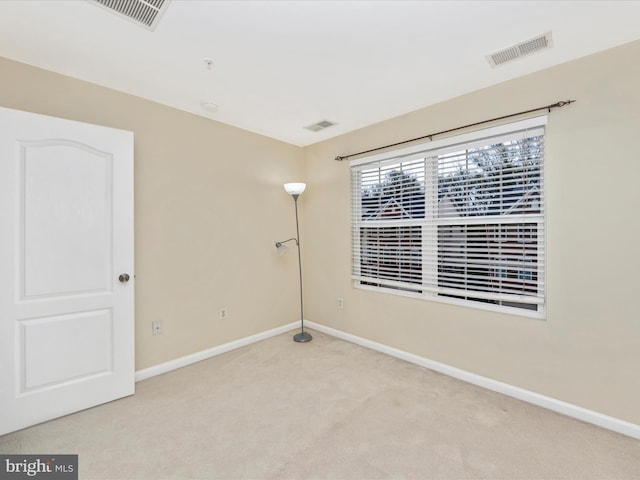 unfurnished room featuring visible vents, baseboards, and carpet flooring