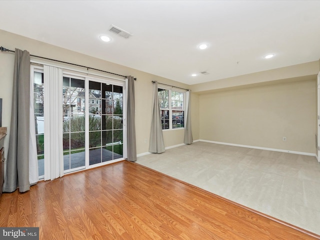 unfurnished room featuring visible vents, baseboards, recessed lighting, and light wood-style floors
