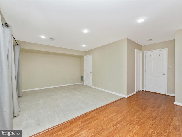 basement with visible vents, baseboards, recessed lighting, and light wood-type flooring