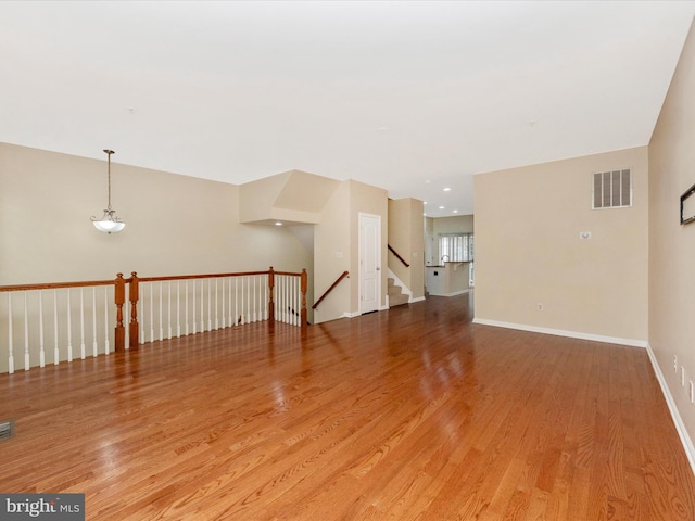 interior space with recessed lighting, visible vents, light wood-type flooring, and baseboards