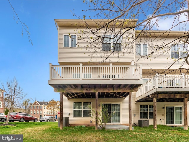 rear view of house featuring a yard, a deck, and central AC