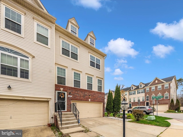 townhome / multi-family property featuring a garage and concrete driveway