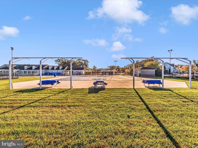 view of playground with a yard, a residential view, and community basketball court