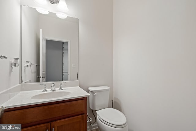 bathroom featuring toilet and vanity