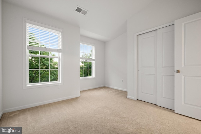 unfurnished bedroom with carpet floors, baseboards, and a closet