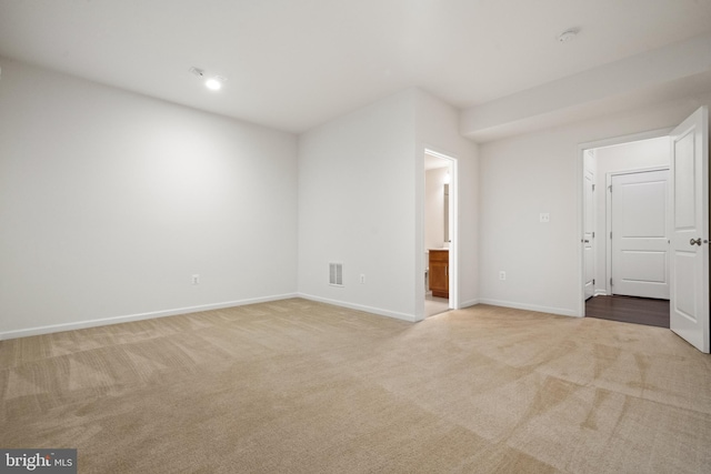 empty room with carpet and baseboards