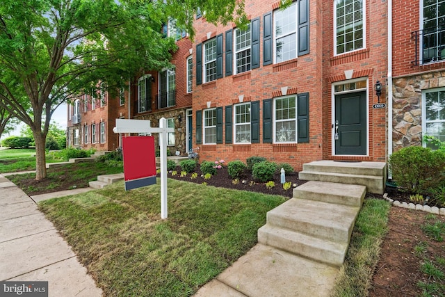 doorway to property with brick siding
