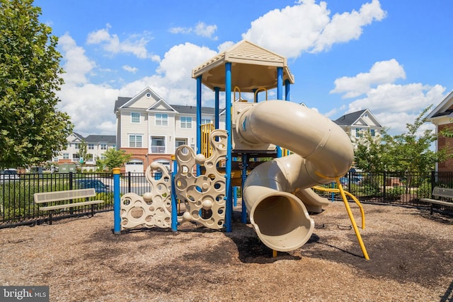 community playground with fence and a residential view