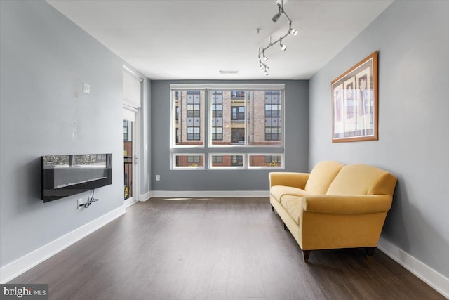 145 Riverhaven Dr Unit 309, Oxon Hill, MD 20745 - living area with dark wood-style flooring and baseboards