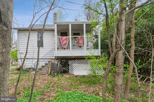 rear view of house with a chimney, central AC unit, and stairs