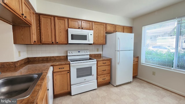 2028 6th St S, Arlington, VA 22204 - kitchen featuring white appliances, a sink, brown cabinets, and backsplash