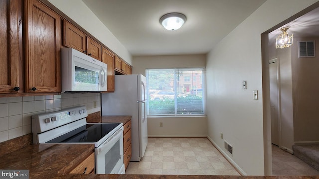 2028 6th St S, Arlington, VA 22204 - kitchen with white appliances, brown cabinetry, backsplash, baseboards, and light floors