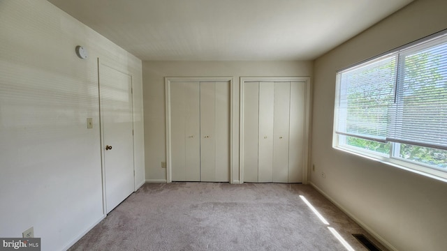 2028 6th St S, Arlington, VA 22204 - unfurnished bedroom with multiple closets, light carpet, and baseboards
