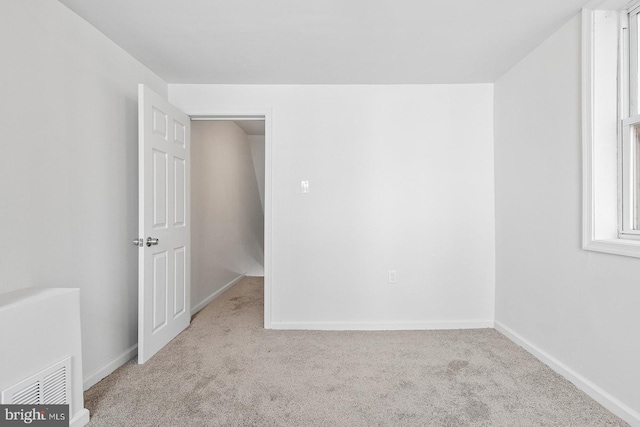 unfurnished bedroom featuring carpet flooring and baseboards