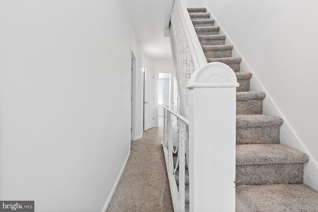 stairs with carpet and baseboards