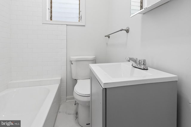 bathroom with toilet, marble finish floor, and vanity