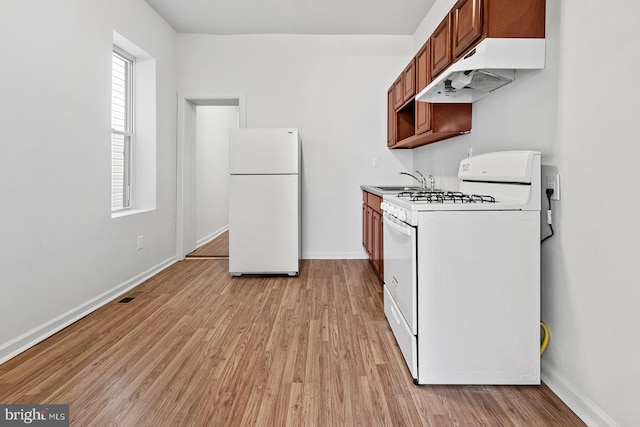 kitchen featuring light wood-style flooring, white appliances, baseboards, and under cabinet range hood