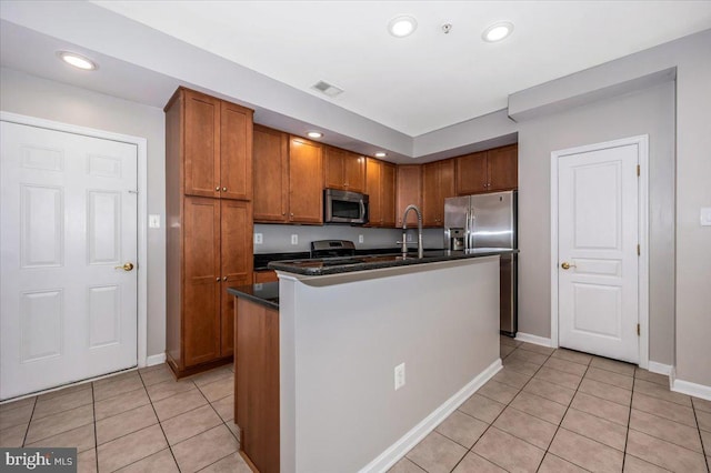 1806 Monocacy View Cir Unit 41A, Frederick, MD 21701 - kitchen with visible vents, dark countertops, brown cabinets, a center island with sink, and stainless steel appliances