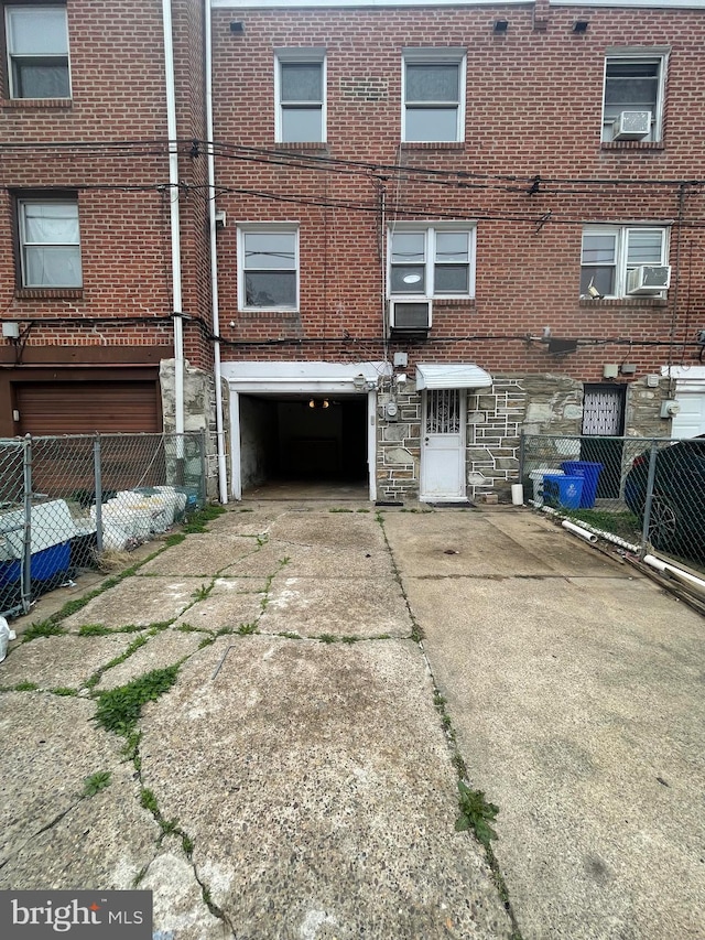 2226 Glenview St, Philadelphia, PA 19149 - back of property featuring concrete driveway, stone siding, fence, and a garage