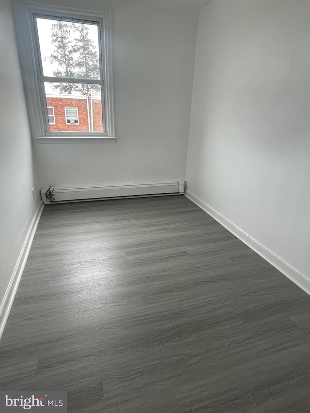 2226 Glenview St, Philadelphia, PA 19149 - empty room featuring dark wood-style flooring, baseboards, and a baseboard heating unit